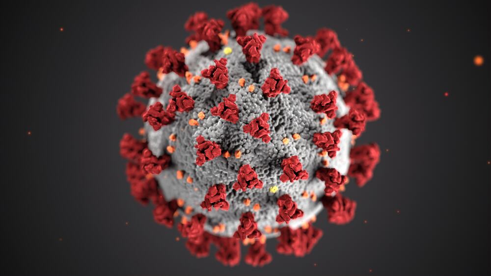 Foto-illustrasjon av koronaviruset - røde og oransje klumper på grå, svampaktig "ball".