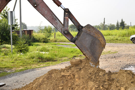 16679240-excavator-bucket-digging-a-trench-in-the-dirt-ground