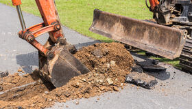 Digger machine operate for digging soil and repair road in the p