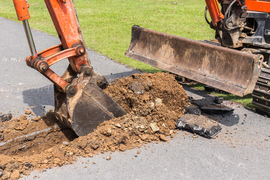 Digger machine operate for digging soil and repair road in the p