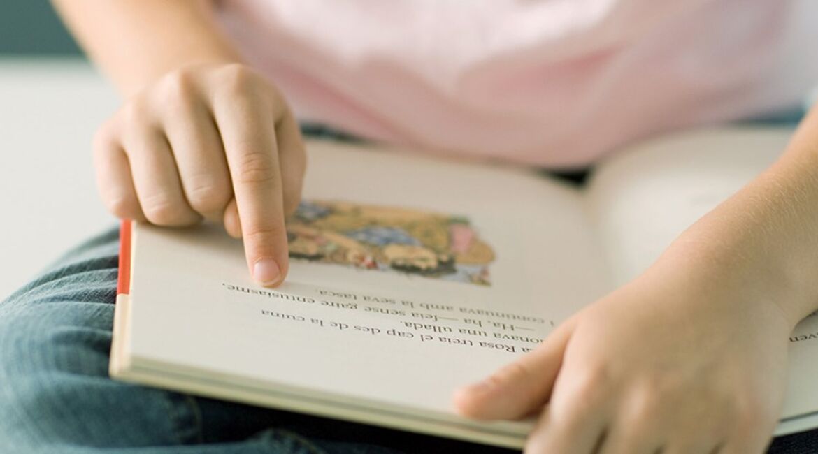 Child reading in a children's book