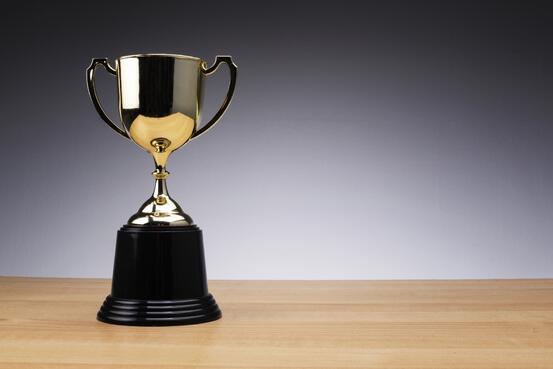 30693860-success-and-winner-concept-golden-trophy-on-wooden-desk