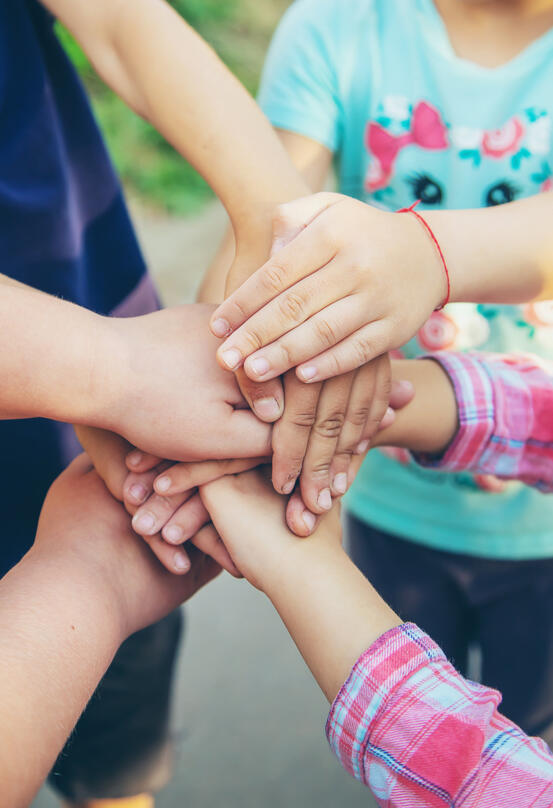 31758626-hands-of-children-many-friends-games-selective-focus