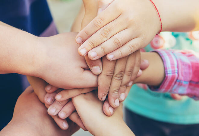 31758626-hands-of-children-many-friends-games-selective-focus